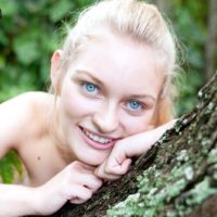 Blue eyed blonde teen Alli Rae flashes her big tits outdoors in a thong and OTK socks