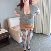 Redhead BBW Greta Grindhouse strips completely naked for the first time on her bed