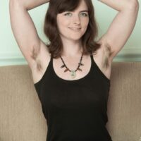 Brown-haired amateur gets rid of her dress and undies to expose her wooly underarms and beaver