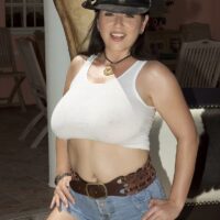 Beautiful brunette Natalie Fiore wets down her hooters while outdoors in a cowgirl hat