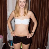 Skinny blonde teen Rachel James tugs on a big cock after being stripped totally naked