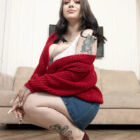 Tattooed solo girl Kira Clark unleashes her huge boobs in high heels on a chesterfield