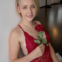 Blonde teen Kamilla takes off red lingerie to get totally naked during solo action