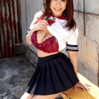 Lovely Oriental babe Ria Sakuragi releases her natural titties from a sailor uniform