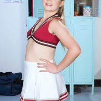 Young cheerleader Lexy demonstrates her flexibility while going topless in cotton undies