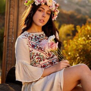 Brunette solo girl Whitney Wright removes a crown of flowers while getting bare naked
