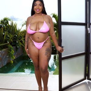 Thick Latina girl Thayana oils up her giant breasts after removing her bikini top