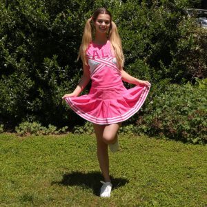 Teen cheerleader Molly Little displays her flexibility after getting naked in a yard