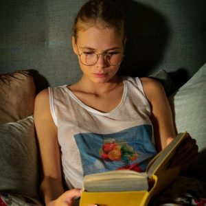 Beautiful blonde nerd Luise reads a book in glasses before masturbating in fetish gear