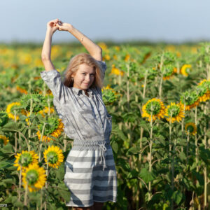 Blonde girl Claire Shelty gets bare naked in a field of sunflowers during solo action