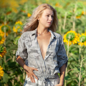 Blonde girl Claire Shelty gets bare naked in a field of sunflowers during solo action