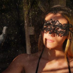 Sexy blonde Stefany shows her firm tits and twat in a mask and crotchless fishnet hose