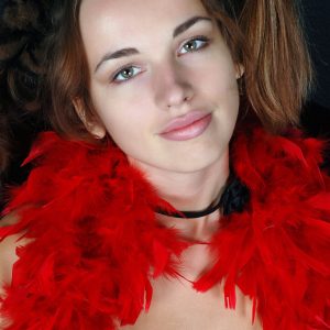 Amateur chick Natalia drapes herself in a red feather boa while modelling in the nude