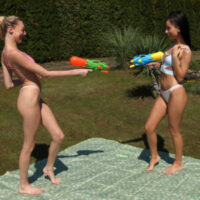 Lesbian girls Kama Oxi and Isabella De Laa get wet before having sex in a backyard