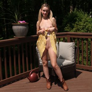 Charming blonde teen Khloe Kingsley pees on the deck after getting completely naked