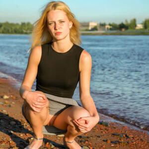 Barely legal blonde Petrina steps into the water while exposing her tight slit